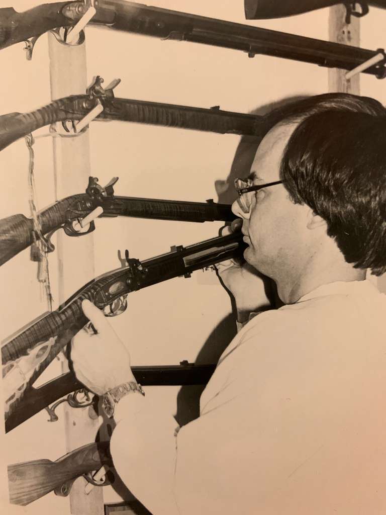 Dan Hopkins hangs a black powder long rifle in his old shop.