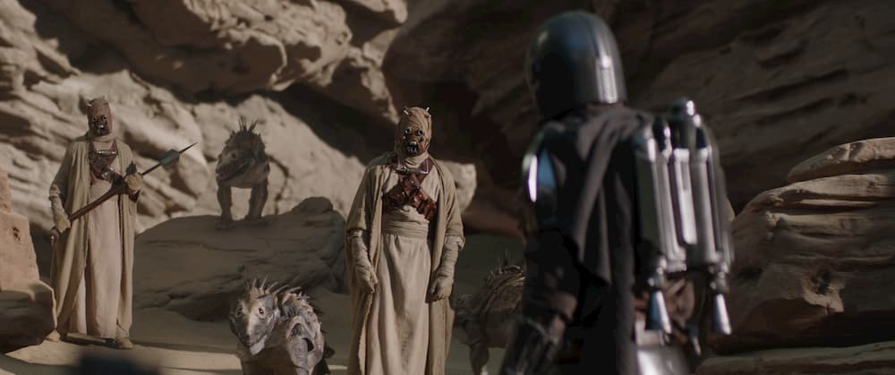 Tusken Raiders and The Mandalorian (Pedro Pascal) in Lucasfilm's THE MANDALORIAN, season two