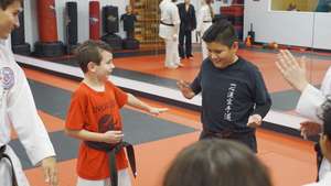 Karate students play "Ninja Tag" in a circle.